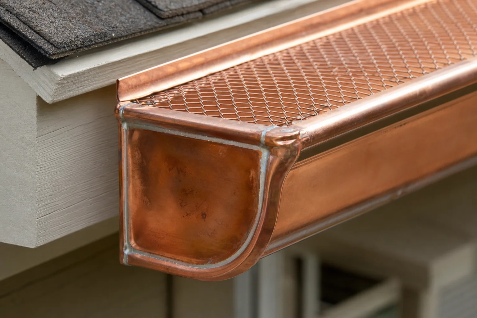 Copper-gutter-protection-installation-premium-home-enhanceme-288-supporting Close-up of soldered copper end caps and gutter guard mesh during installation